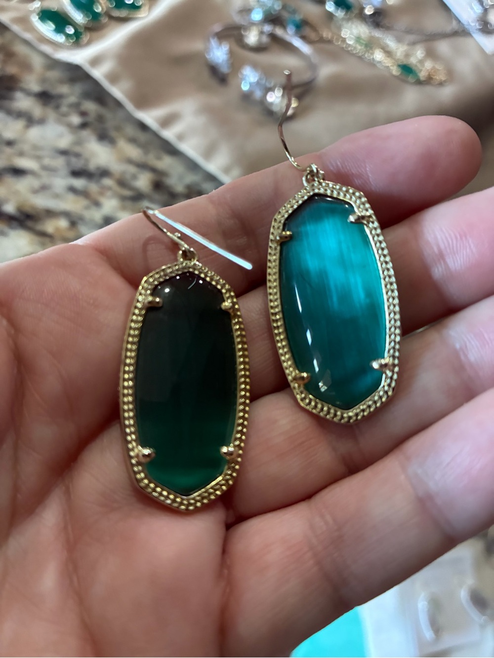 Kendra Scott gold Elle drop earrings in emerald cats eye green.
